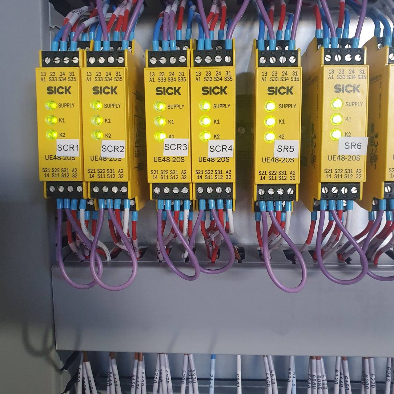 Row of safety relays wired in a control panel