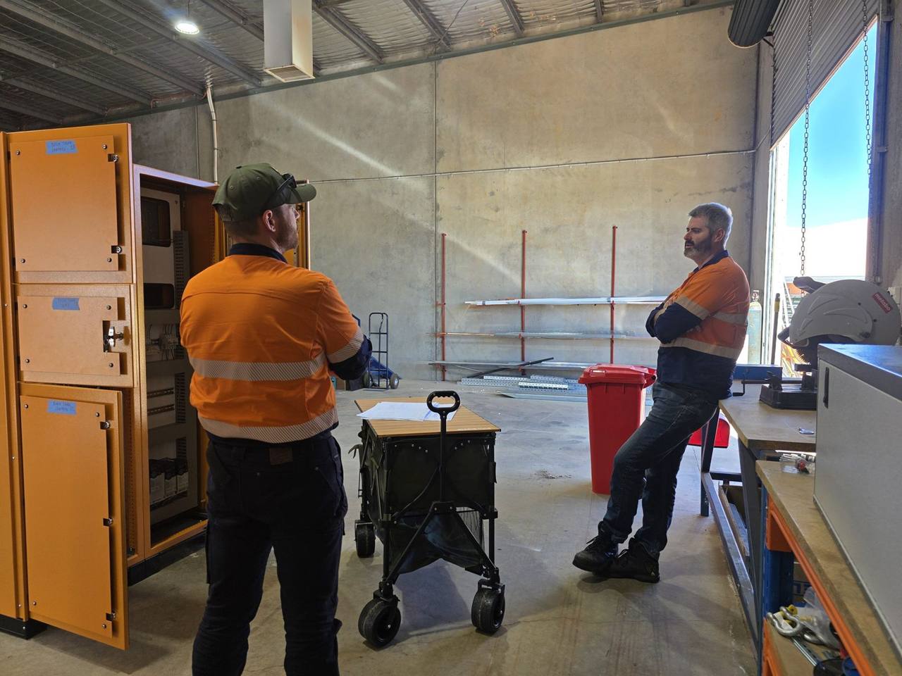 The AMC team with a switchboard in the workshop