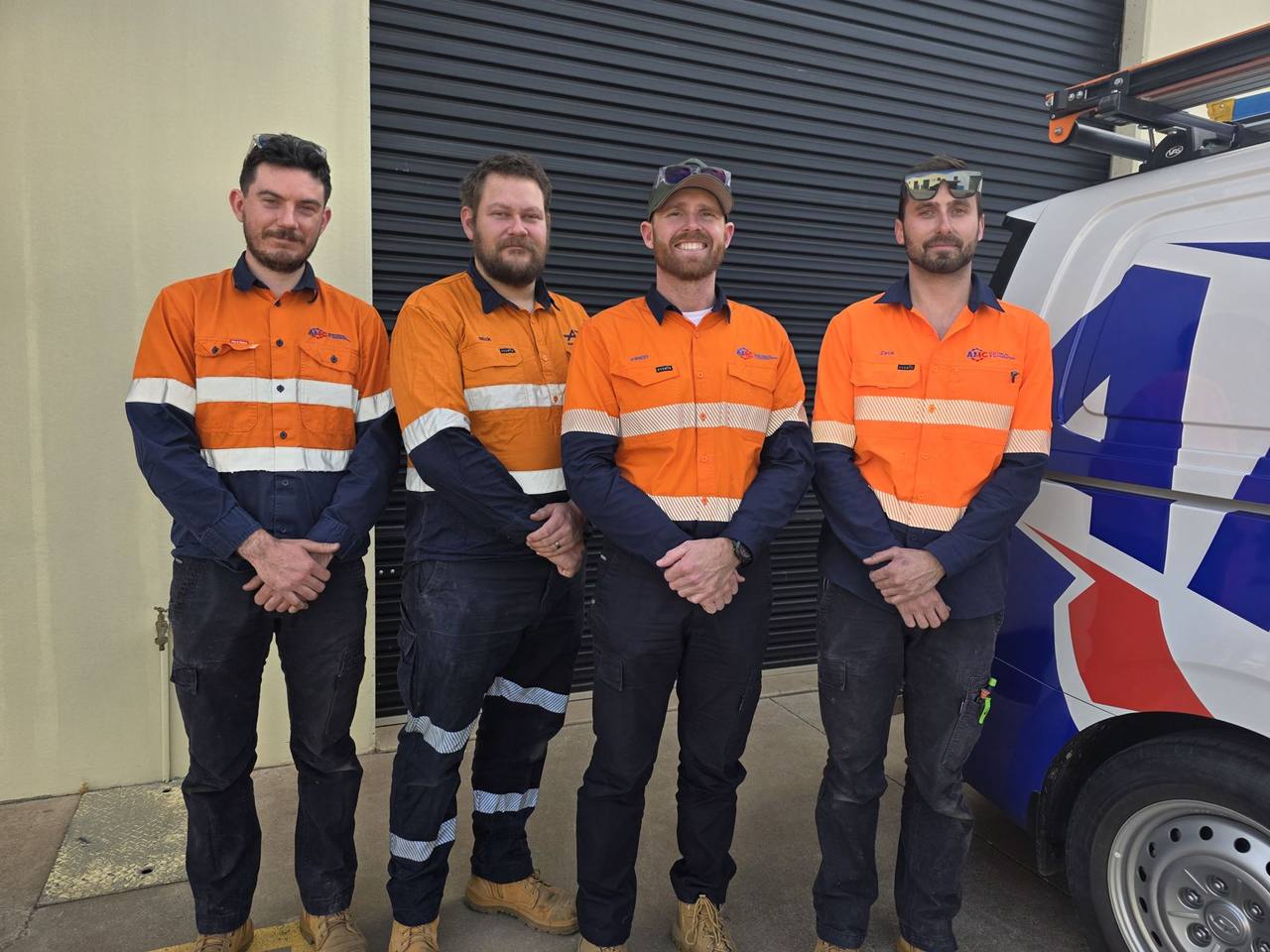 The AMC Electrical & Automation field crew in hi-vis beside the company van